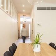 A globe light is the centrepiece in this ceiling, floor, flooring, hardwood, home, interior design, laminate flooring, light fixture, lighting, property, real estate, room, table, wall, wood, wood flooring, white, orange