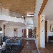 The dining area and entrance flow down to architecture, ceiling, daylighting, estate, floor, flooring, house, interior design, living room, property, real estate, room, gray