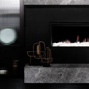 A fireplace draws the eye in this lounge fireplace, hearth, interior design, black