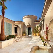 The Spanish influence is certainly clear in this courtyard, estate, hacienda, home, mansion, property, real estate, villa, orange, brown