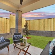 The sheltered seating area looks out to the architecture, backyard, estate, home, house, interior design, living room, patio, property, real estate, wall, window, wood, gray, orange