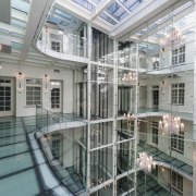 A large atrium features opaque glass floors - apartment, building, condominium, daylighting, glass, property, real estate, window, gray