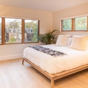 This large bedroom features ample space and light bed, bed frame, bed sheet, bedroom, ceiling, estate, floor, flooring, hardwood, home, interior design, laminate flooring, mattress, property, real estate, room, wall, window, wood, wood flooring, white, orange