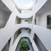 This courtyard area is a like a set apartment, architecture, building, condominium, daylighting, facade, headquarters, house, real estate, stairs, white