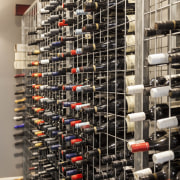 The wine cellar is simple and functional - inventory, wine cellar, black, gray