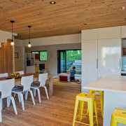 The living room features white cabinetry with a house, interior design, real estate, table, brown, gray