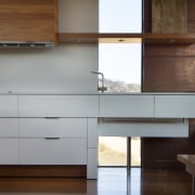 This window runs down to the floor – architecture, cabinetry, chest of drawers, countertop, furniture, hardwood, interior design, kitchen, wood, brown, white