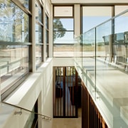 A wide stairway connects all levels of this apartment, architecture, building, daylighting, glass, handrail, house, interior design, real estate, window, white, gray