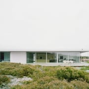Large, floor to ceiling glass windows and doors architecture, facade, home, house, real estate, white