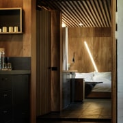 The light behind this bed reminds us of architecture, bathroom, ceiling, floor, interior design, lighting, room, wood, black, brown