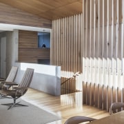 In this space, the concrete seems to balance architecture, ceiling, daylighting, floor, flooring, interior design, lobby, wall, wood, brown, gray