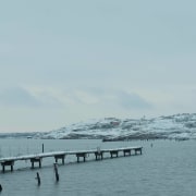 A wharf running out into the water - cloud, coast, coastal and oceanic landforms, horizon, ocean, sea, shore, sky, water, waterway, wave, wind wave, gray
