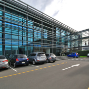 Exterior - Exterior shot - airport terminal | airport terminal, building, car, city, corporate headquarters, family car, infrastructure, lane, luxury vehicle, metropolis, metropolitan area, motor vehicle, parking, parking lot, road, sedan, structure, transport, gray