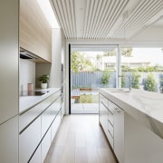 The kitchen opens right out onto the backyard architecture, ceiling, countertop, daylighting, floor, house, interior design, kitchen, real estate, window, gray, white