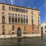 It was built between the 15th and 16th building, château, city, classical architecture, estate, facade, historic site, landmark, medieval architecture, palace, plaza, tourist attraction, town, water, waterway, window, orange