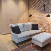 Another view of the brick feature wall and ceiling, couch, floor, flooring, furniture, hardwood, home, interior design, living room, loft, property, real estate, room, wall, wood, wood flooring, gray, orange