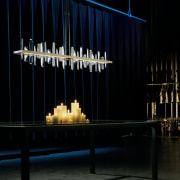 The Solitude is a modern take on the chandelier, darkness, light, light fixture, lighting, stage, black