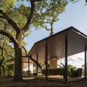 The roof line adjusts for the trees - architecture, cottage, farmhouse, home, house, pavilion, property, real estate, tree, brown