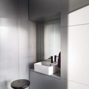 This tiny bathroom is distinctly modern and features floor, interior design, product design, tap, white, gray