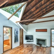 This triangular window lights up the living room architecture, beam, ceiling, daylighting, floor, hardwood, home, house, interior design, laminate flooring, living room, real estate, roof, window, wood, wood flooring, white