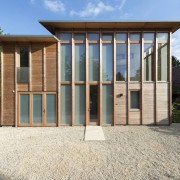 Glass runs from the ground floor up to architecture, facade, home, house, property, real estate, shed, white