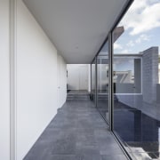 The hallway faces out to the swimming pool apartment, architecture, building, daylighting, facade, floor, glass, house, interior design, real estate, white, gray