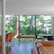 The new glass wall and leafy backyard views. 