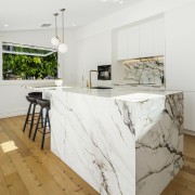 The existing refinished floor complements the Neolith Calacatta 