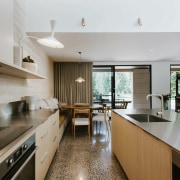 Slender stainless steel benchtops feature on the island 