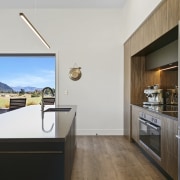 Wood floors chime with the warm toned cabinetry. 