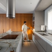 Contemporary kitchen with island finished in local stone 