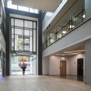 A double-height formal entry on Boulcott Street greets apartment, architecture, building, condominium, daylighting, glass, house, interior design, lobby, metropolitan area, mixed use, gray, black