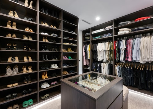 Within the walk-in robe, a custom-designed island serves 
