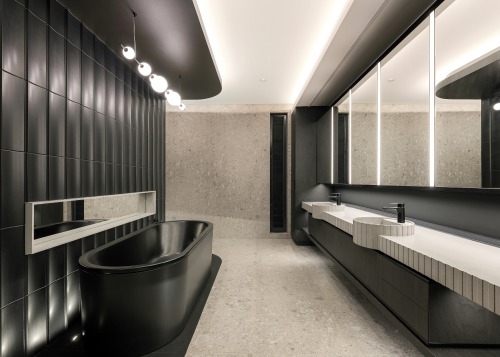 The bathings space's crenulated wall finish is echoed 