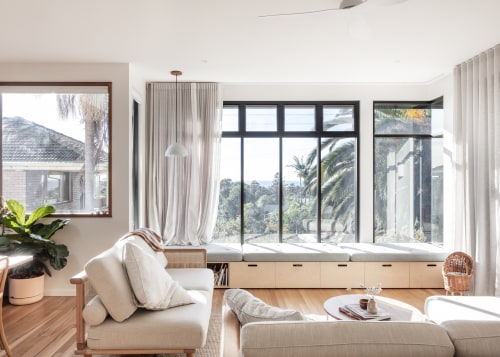 Consecutive vertical windows above the daybed frame the 