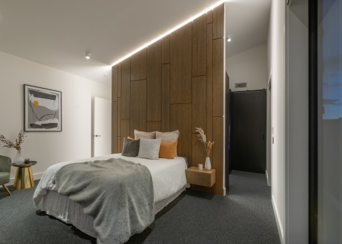 Bedroom with feature headboard / space divider. 
