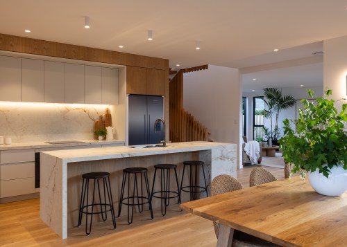 Overhead cabinetry and concealed storage ensure everyday essentials 