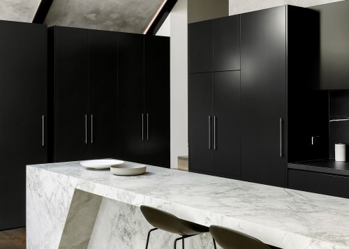 The angled knee-room niche echoes the room without 