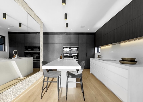 Black and white kitchen surfaces are grounded by 