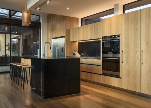 ​​​​​​​Recessed track spots above this benchtop provide a architecture, kitchen, cabinetry, countertop, cupboard, timber flooring, home, house, interior design, kitchen, wood flooring, wood stain, brown, black, lighting, feature lighting, fisher & Paykel, Eliska Lewis Architects
