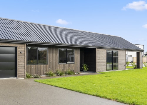 The double garage door provides subtle contrast to 