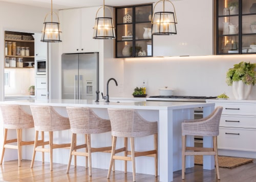 The kitchen boasts predominantly pale, refined tones. 