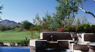 Close view of the water feature located beside backyard, estate, home, landscape, landscaping, leisure, plant, property, real estate, sky, swimming pool, tree, villa, water, water feature, teal