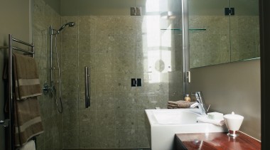 The view of a bathroom featuring a shower, architecture, bathroom, floor, flooring, glass, interior design, plumbing fixture, property, room, tile, wall, black