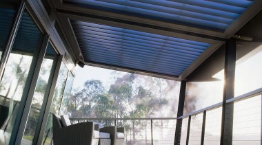 View of a netted urban balcony features polished architecture, ceiling, daylighting, roof, structure, white, black