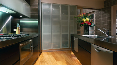 The view of a contemporary kitchen with dark cabinetry, ceiling, countertop, floor, flooring, hardwood, interior design, kitchen, laminate flooring, real estate, room, wood flooring, brown