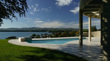 Overlooking the views from this Mediterranean-style house architecture, cloud, estate, home, house, property, real estate, resort, sea, sky, swimming pool, tree, villa, water, black