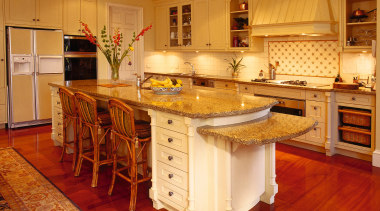 View of the kitchen area - View of cabinetry, countertop, cuisine classique, floor, flooring, furniture, hardwood, interior design, kitchen, laminate flooring, room, wood, wood flooring, orange, red