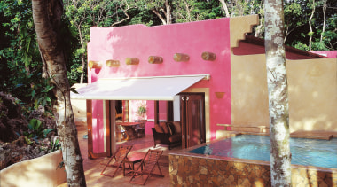 Pink coloured hotel room with awning over outdoor cottage, hacienda, home, house, property, real estate, resort, black