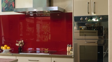 Kitchen with cream cabinetry, red splashback and stainless cabinetry, countertop, cuisine classique, furniture, home appliance, interior design, kitchen, kitchen stove, room, brown, orange